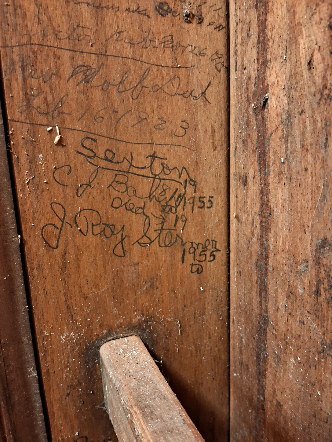 Historic names and dates written inside the Water Street vestibule ladder enclosure
